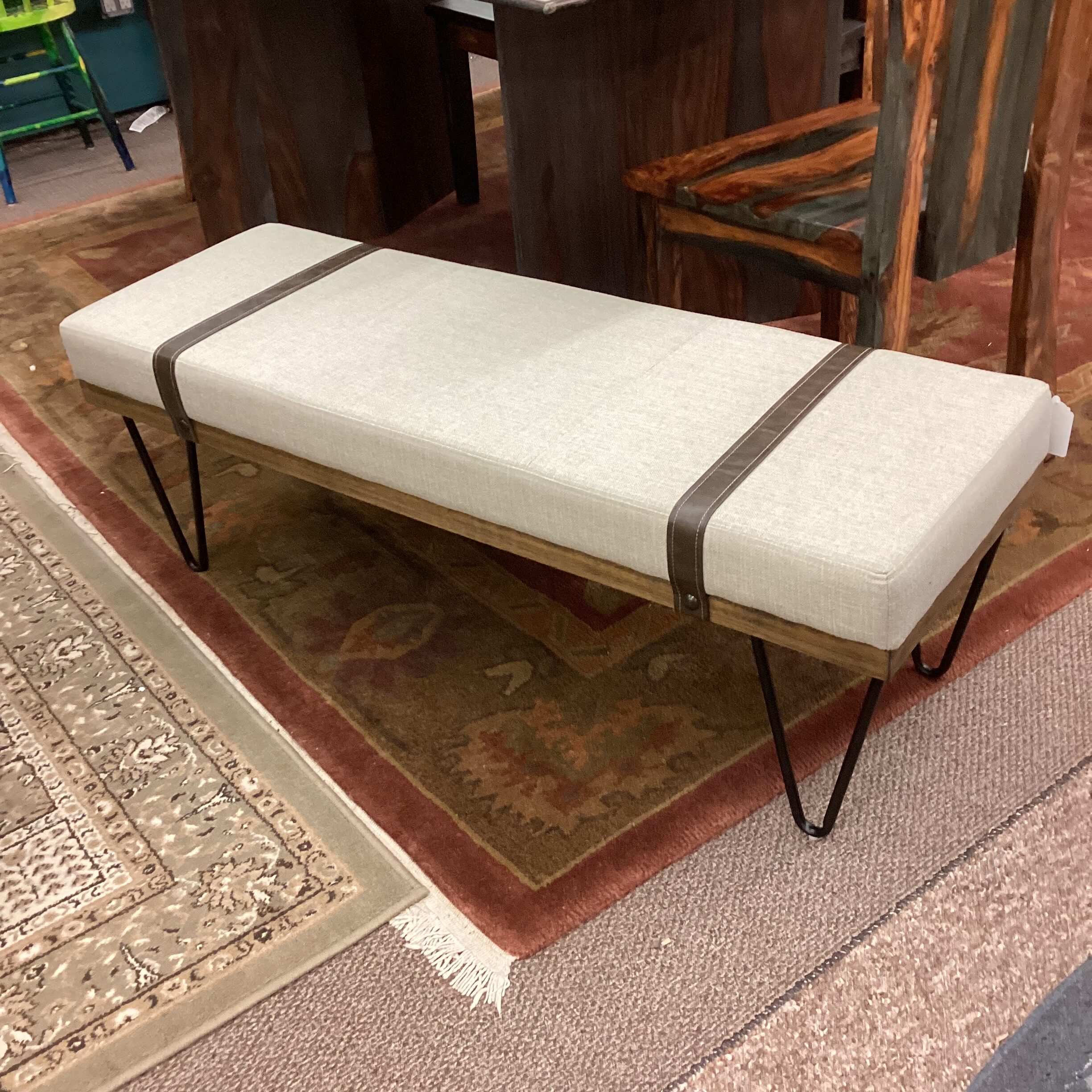 beige strapped wood bench