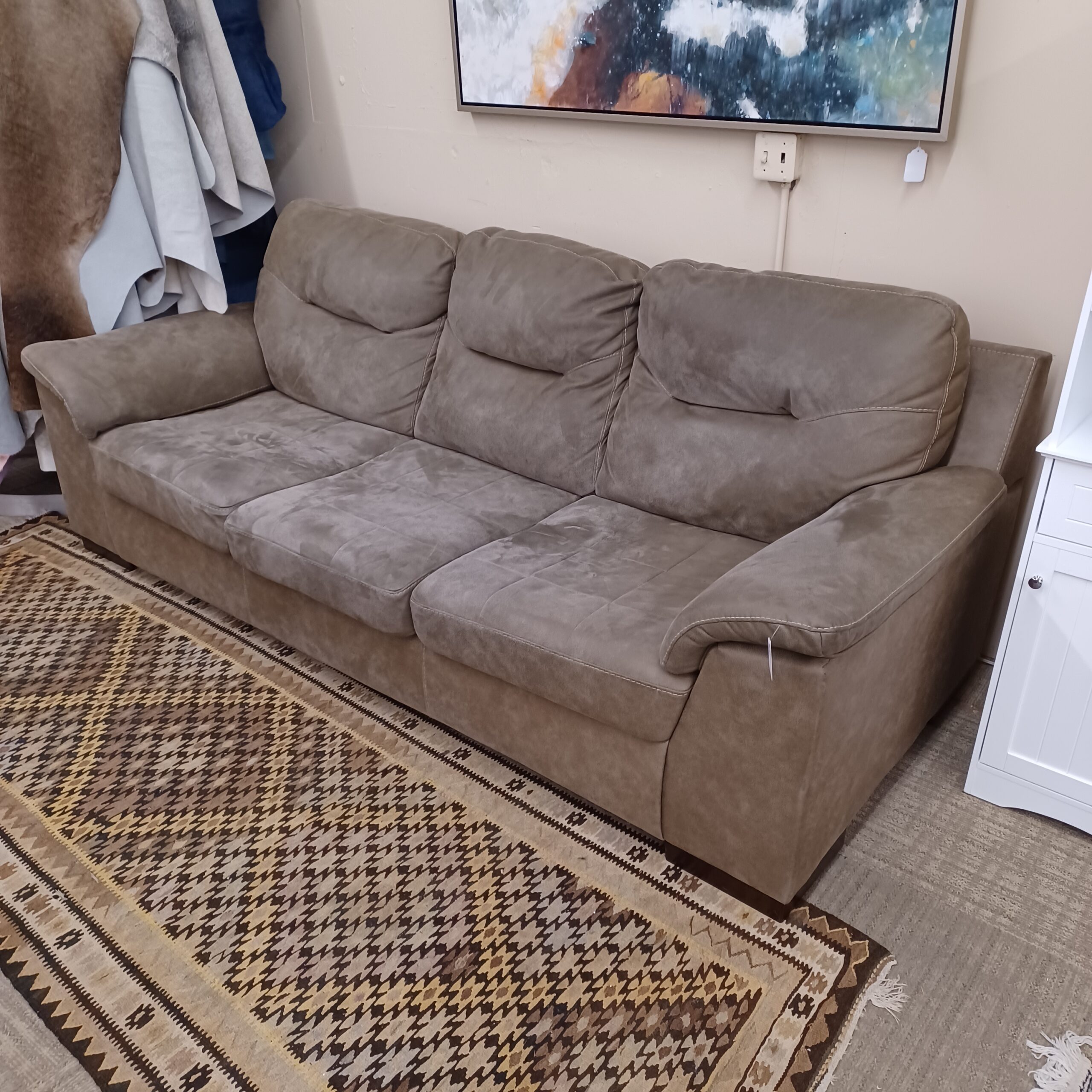 grey three seat sofa w/white stitching (as is)